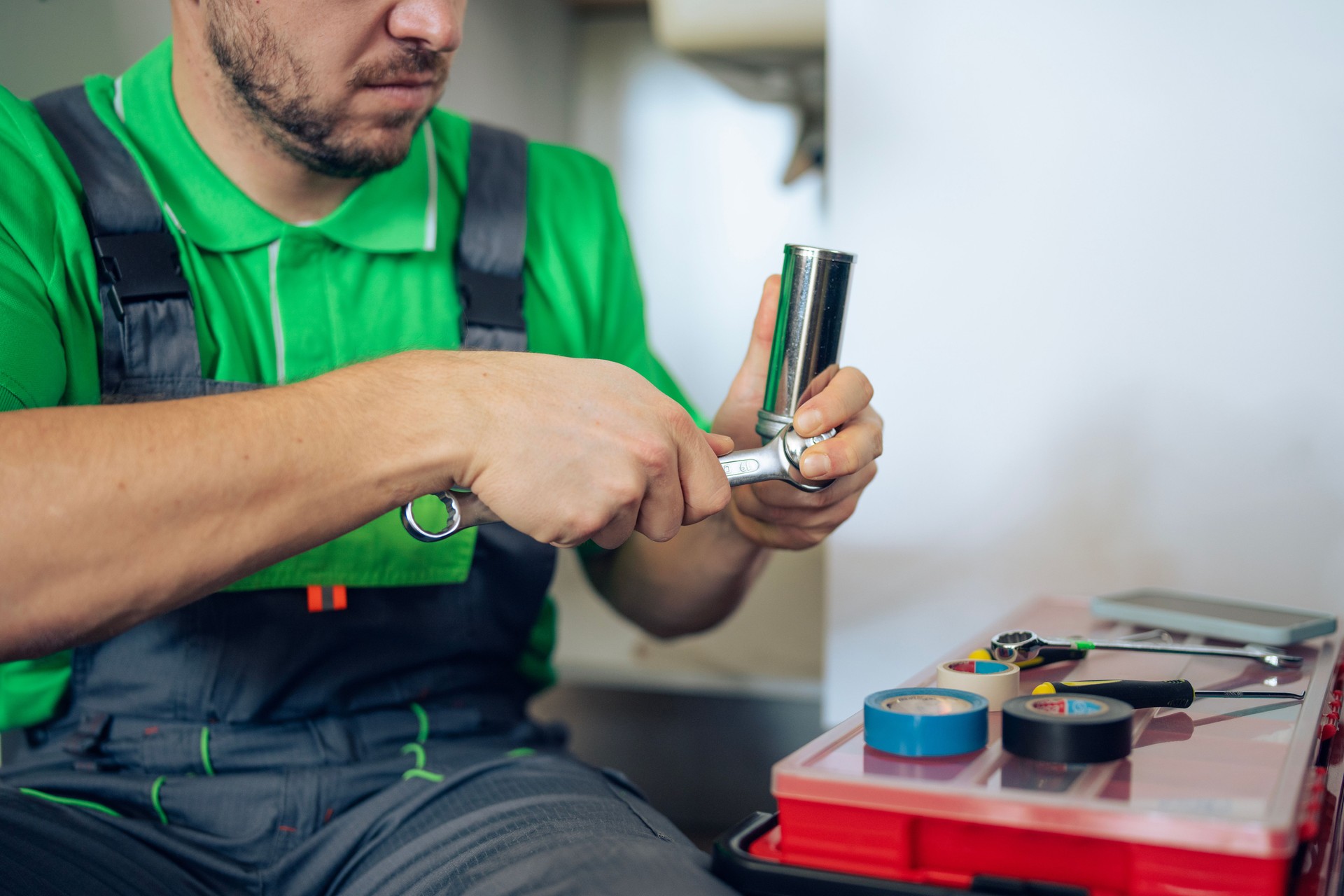 Experienced plumber fixing a clogged kitchen sink in a private home